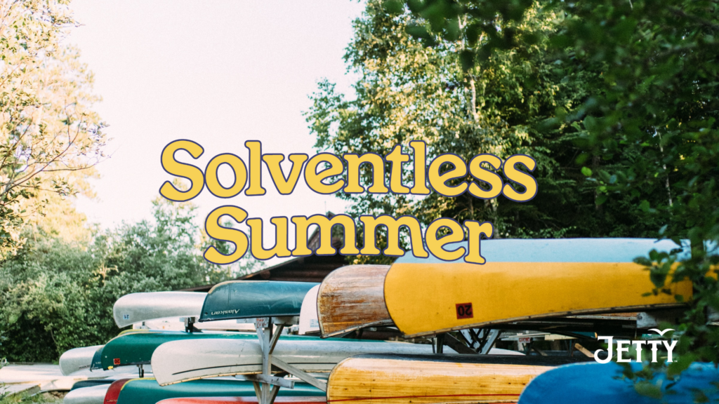 Solvenltess Summer in Yellow Font over a photo of canoes stacked upon one another.
