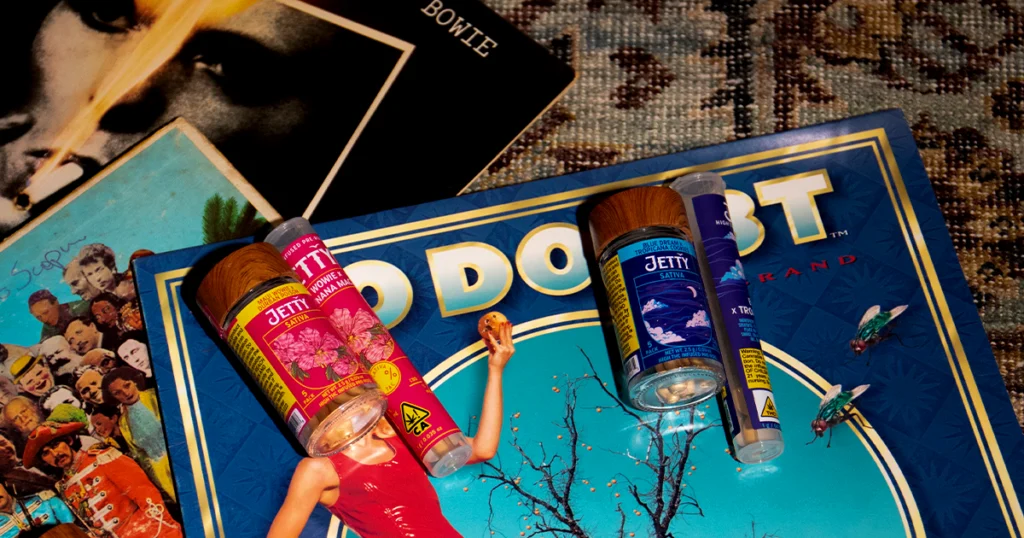 Jetty High-THC infused pre-roll jars and tubes rest on vintage vinyl album covers, including records by David Bowie, The Beatles, and No Doubt, reflecting Jetty’s Greatest Hits campaign theme that connects cannabis craftsmanship with classic music culture.