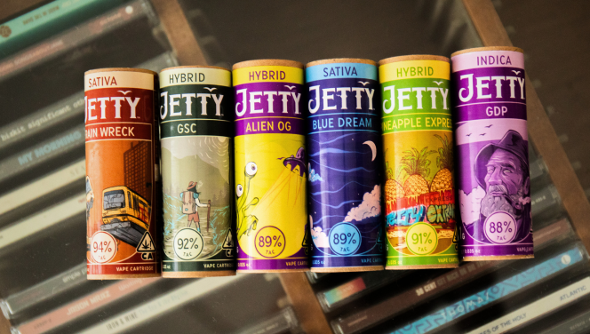 A rainbow of colored canisters of Jetty Extracts Vape Carts with Peel-nstick strain names.