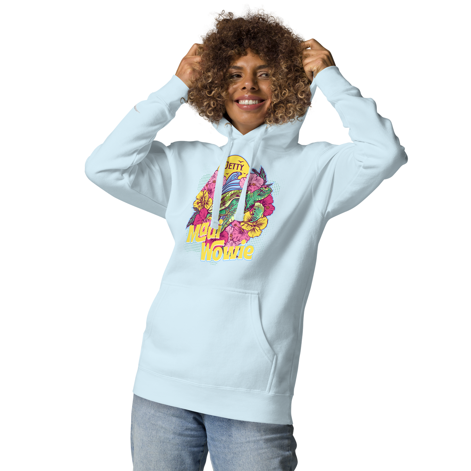 Smiling person wearing a light blue Jetty Extracts Maui Wowie hoodie featuring a bold, colorful graphic with tropical flowers, ocean waves, and retro lettering. Cannabis lifestyle apparel, stoner streetwear, weed strain hoodie inspired by Maui Wowie, perfect for casual wear, festival outfits, and Jetty Extracts merch fans.