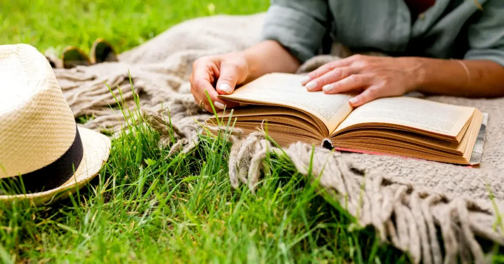 Open book on a blanket in natural light representing research behind The Emperor Wears No Clothes